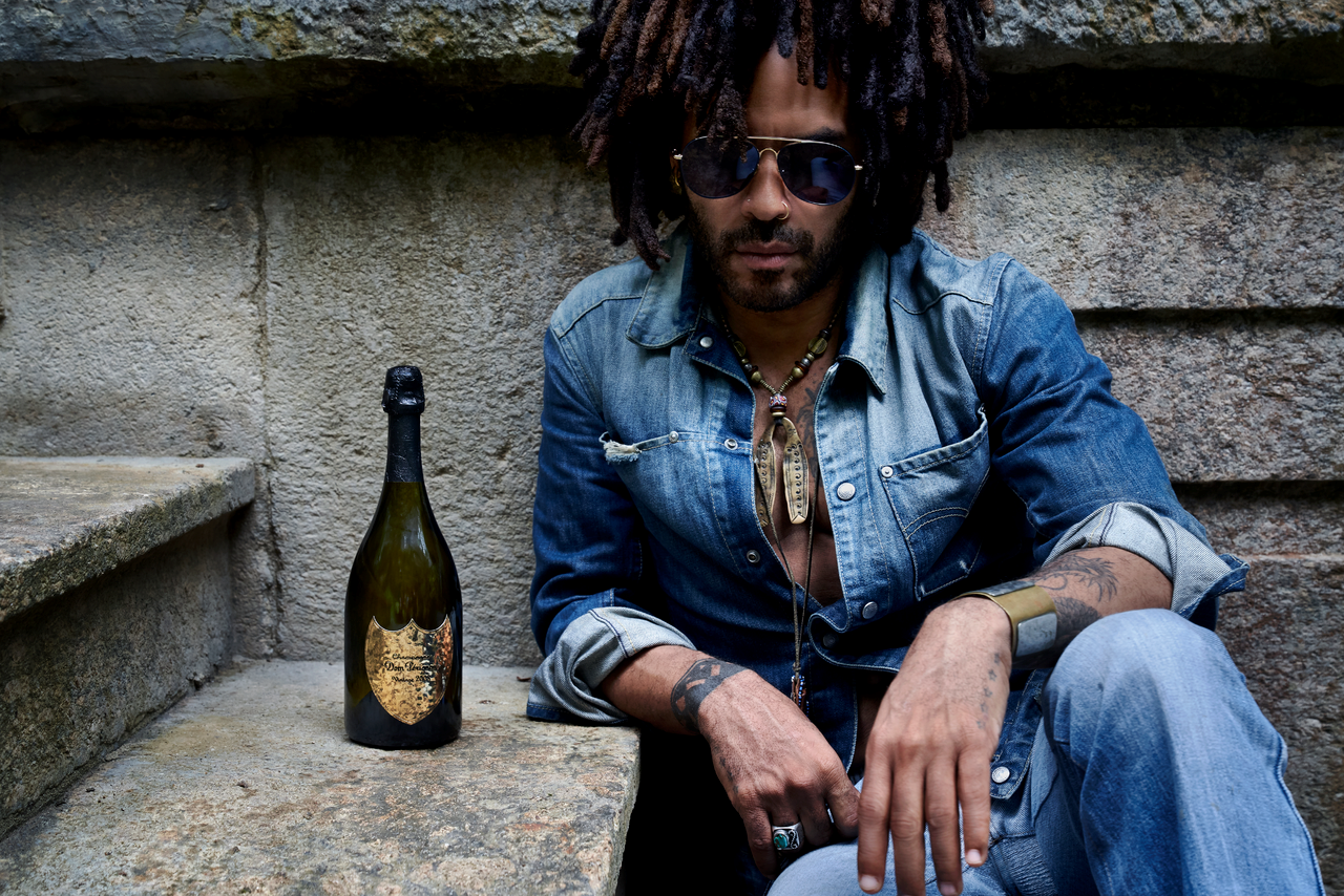 Lenny Kravitz sitting next to a bottle of dom perignon limited edition